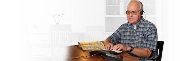 Older adult male wearing a headset and using Hearing carry-over to make a call.