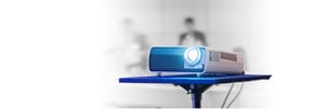Image of a digital projector on a stand.