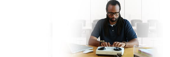 African American male using TTY for a phone call.